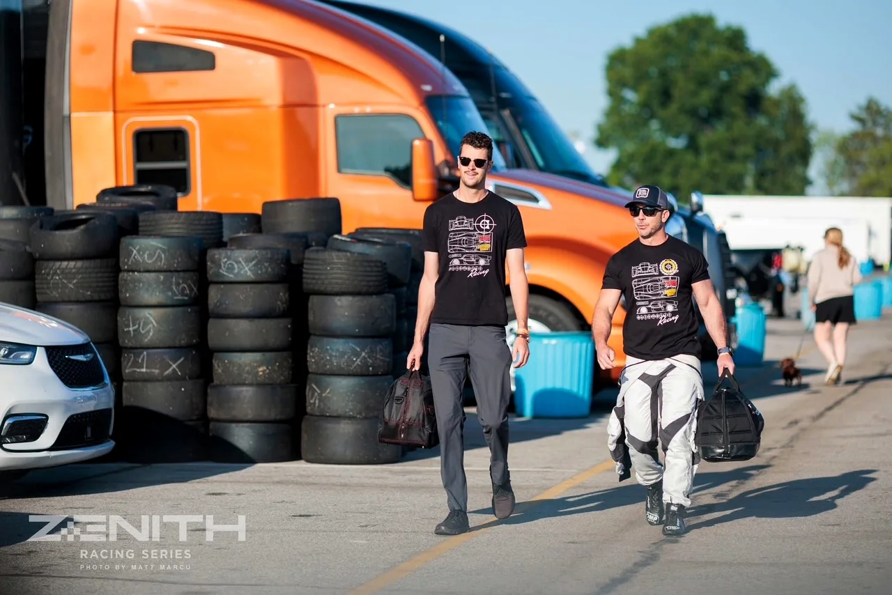 Rob Pellosie and teammate walking through the paddock